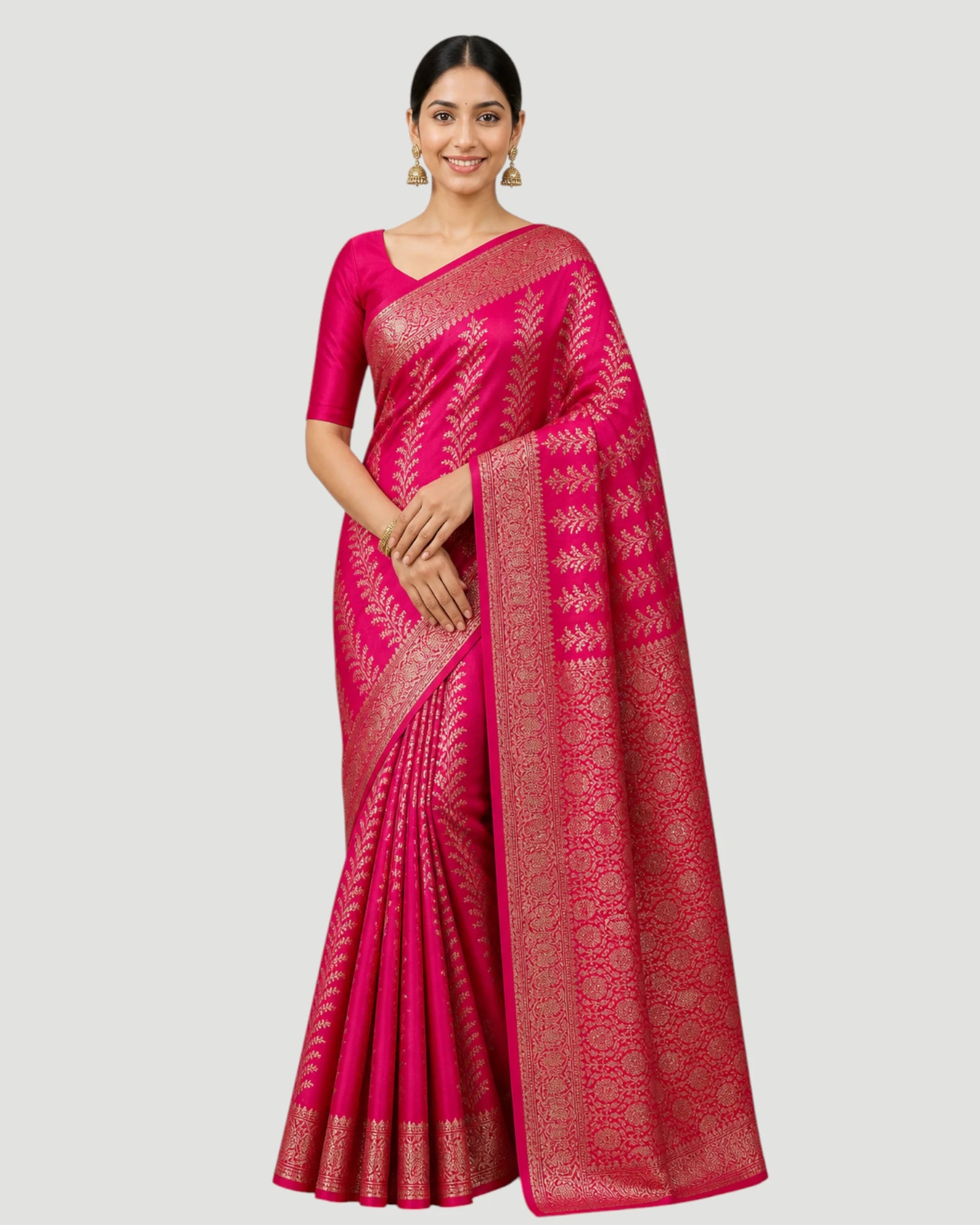 Woman wearing a pink saree with a white border on a light gray background