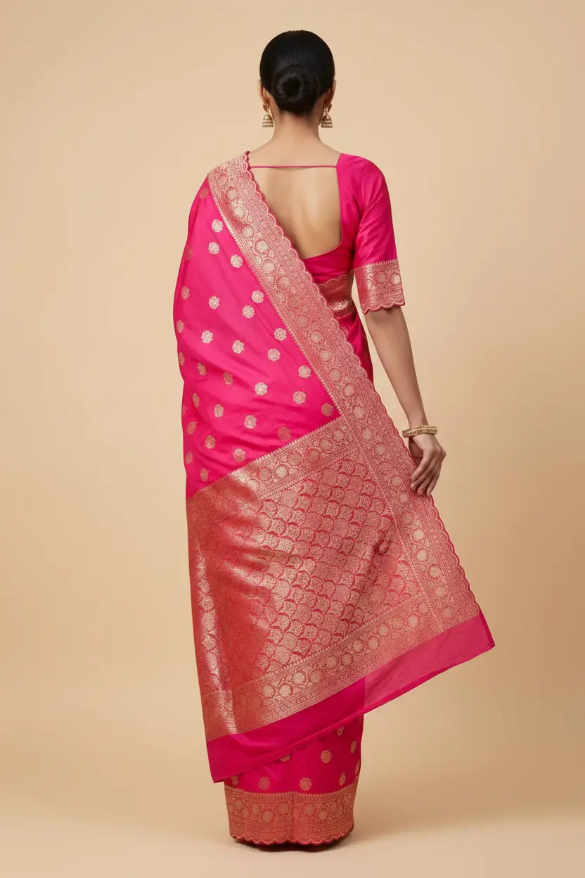 Woman wearing a pink saree with a beige background