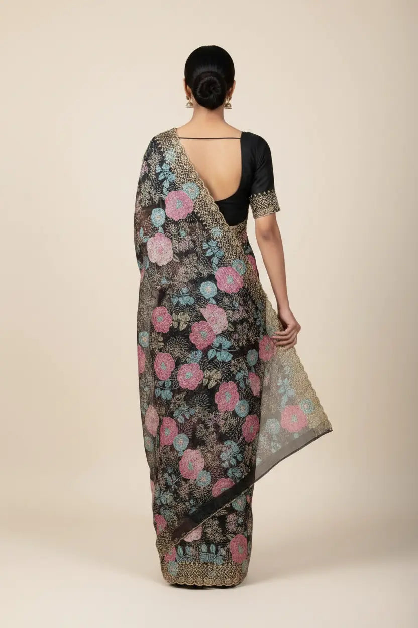 Woman wearing a floral saree with a plain background