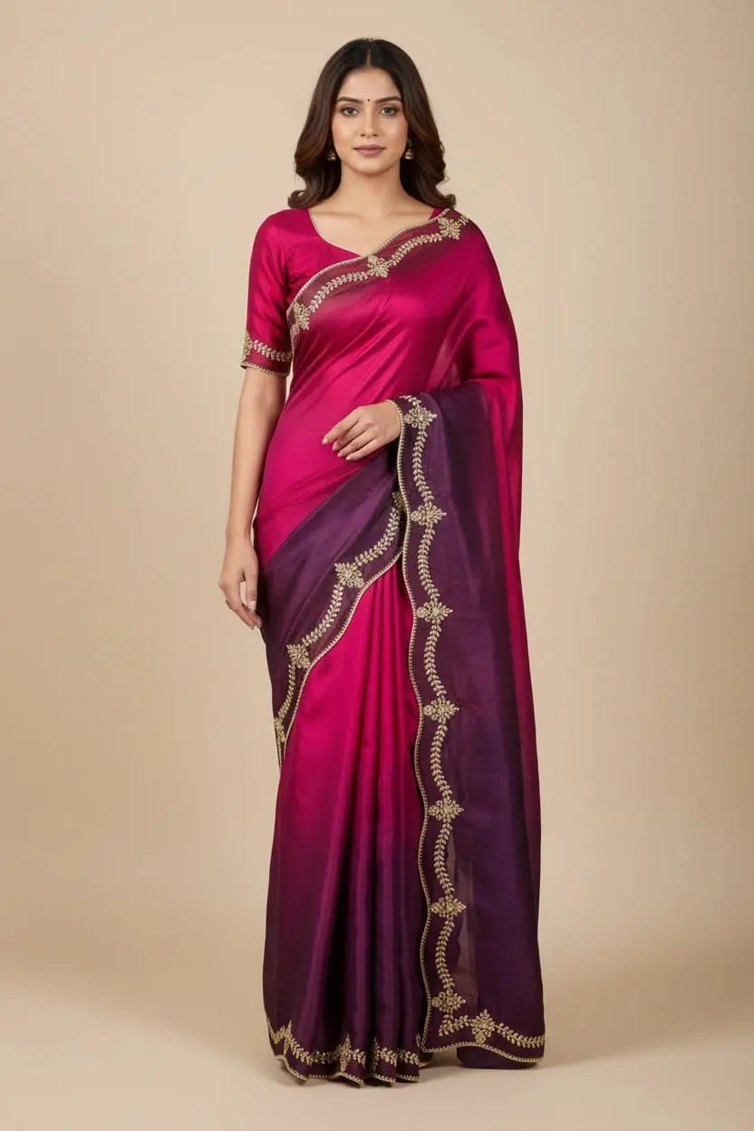 Woman wearing a pink and purple saree with intricate border on a beige background