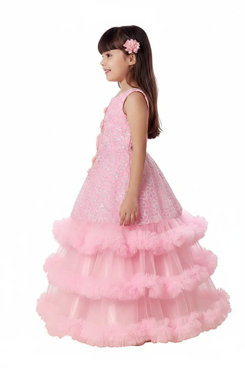 Young girl wearing a pink dress with floral details on a white background
