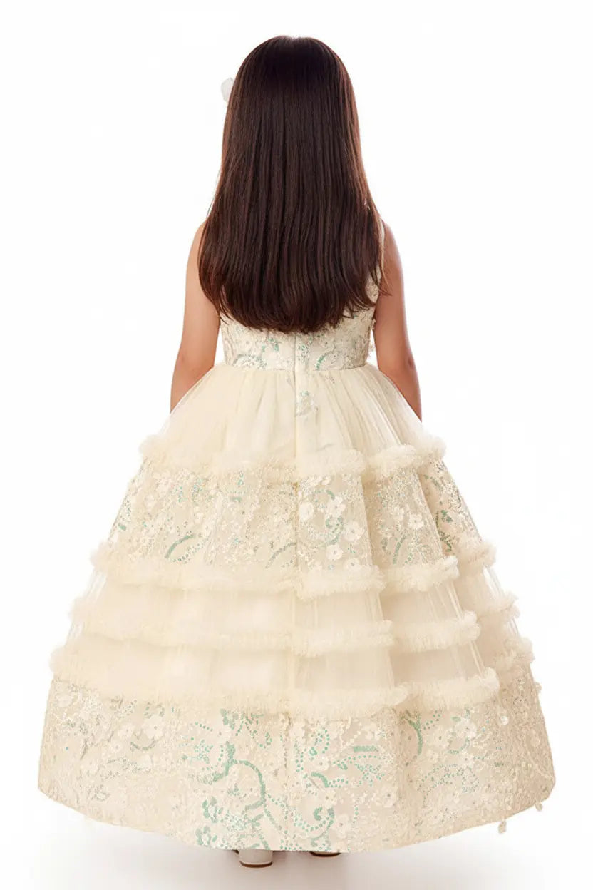 Woman wearing a beige floral embroidered dress on a white background