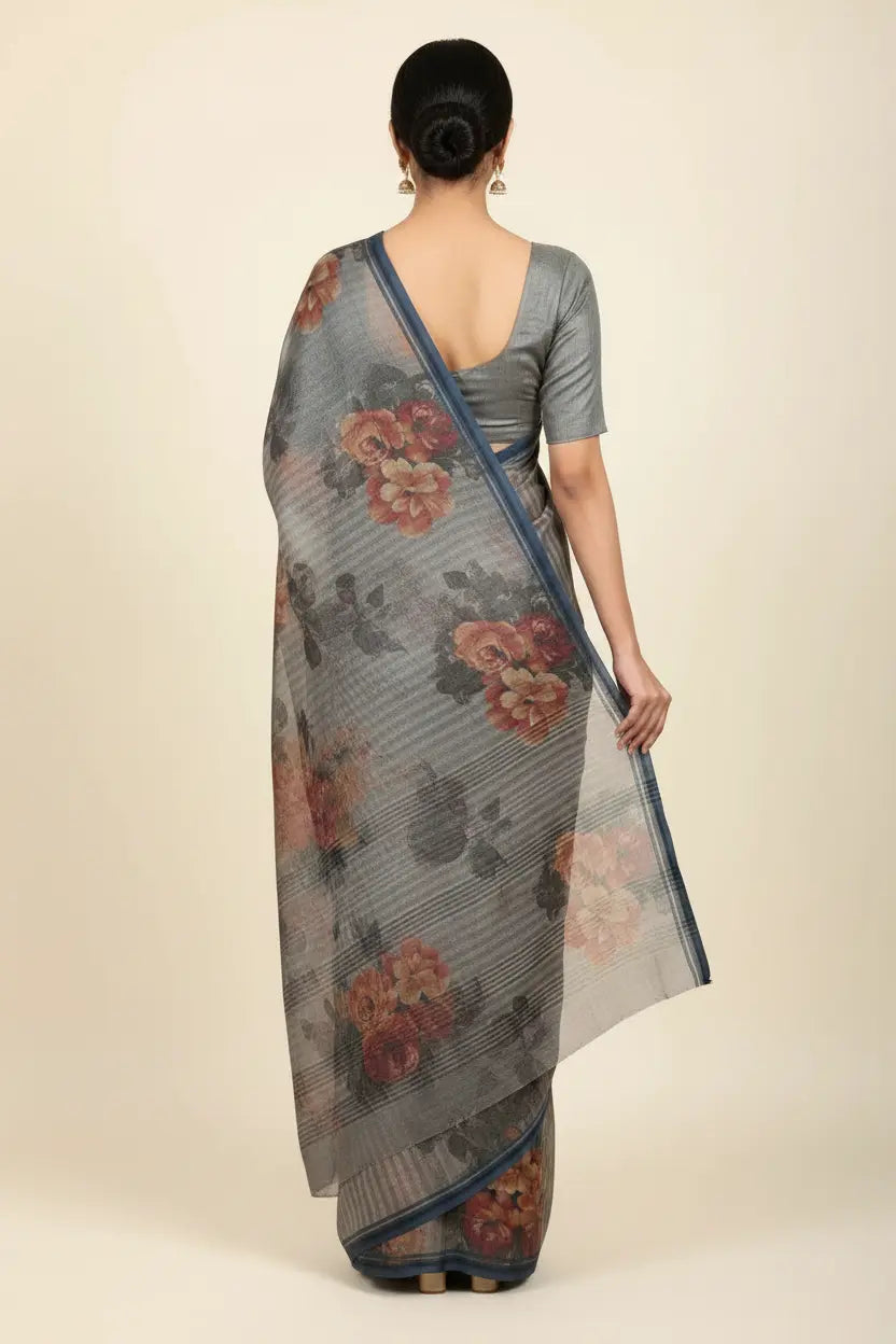 Woman wearing a gray floral saree on a beige background