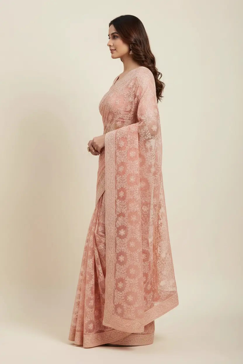Woman wearing a pink traditional outfit with a matching dupatta on a beige background
