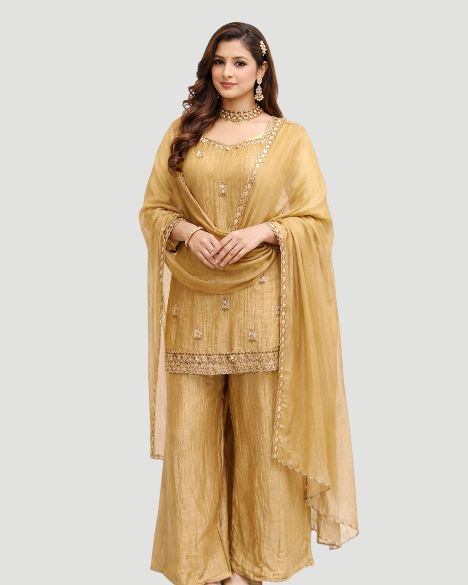 Woman wearing a mustard yellow traditional outfit with a dupatta on a white background