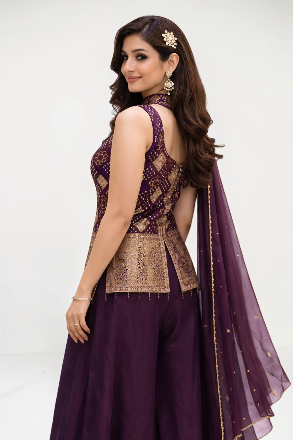 Woman wearing a purple traditional outfit with gold embroidery on a white background