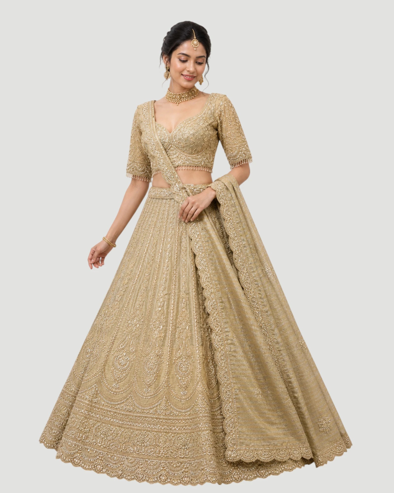 Woman wearing a beige embroidered lehenga on a white background