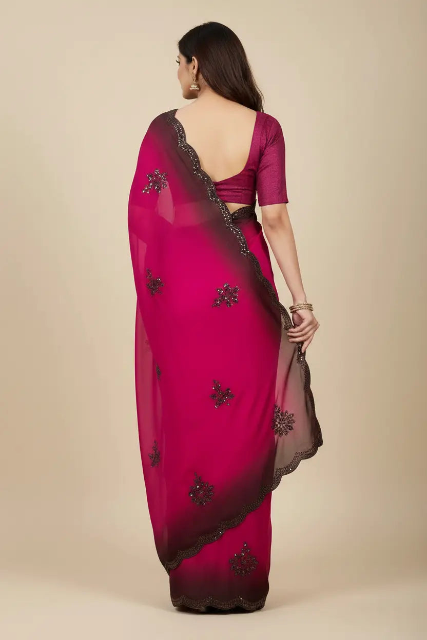Woman wearing a pink saree with black floral patterns on a beige background