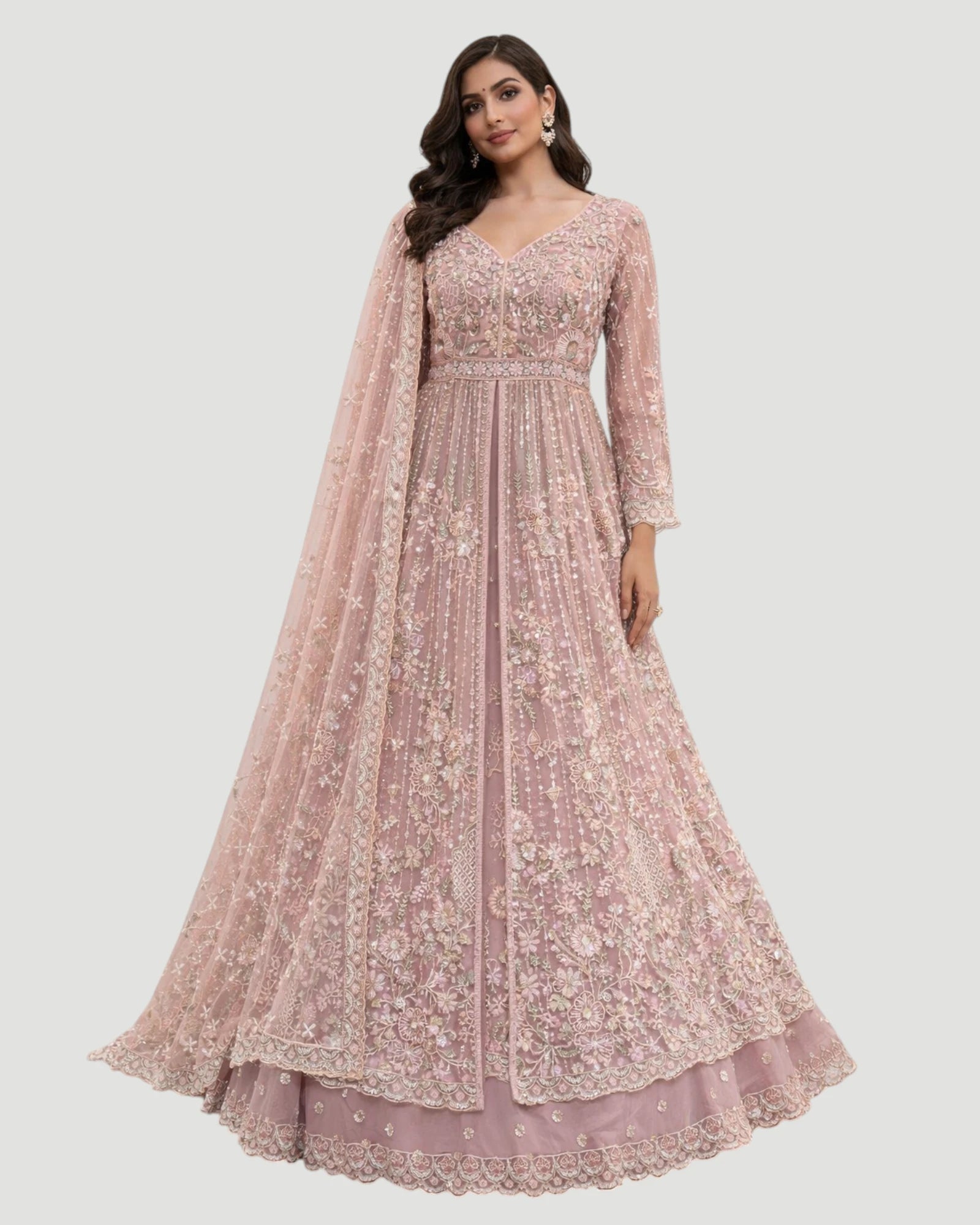 Woman wearing a pink embroidered gown with a matching dupatta on a white background