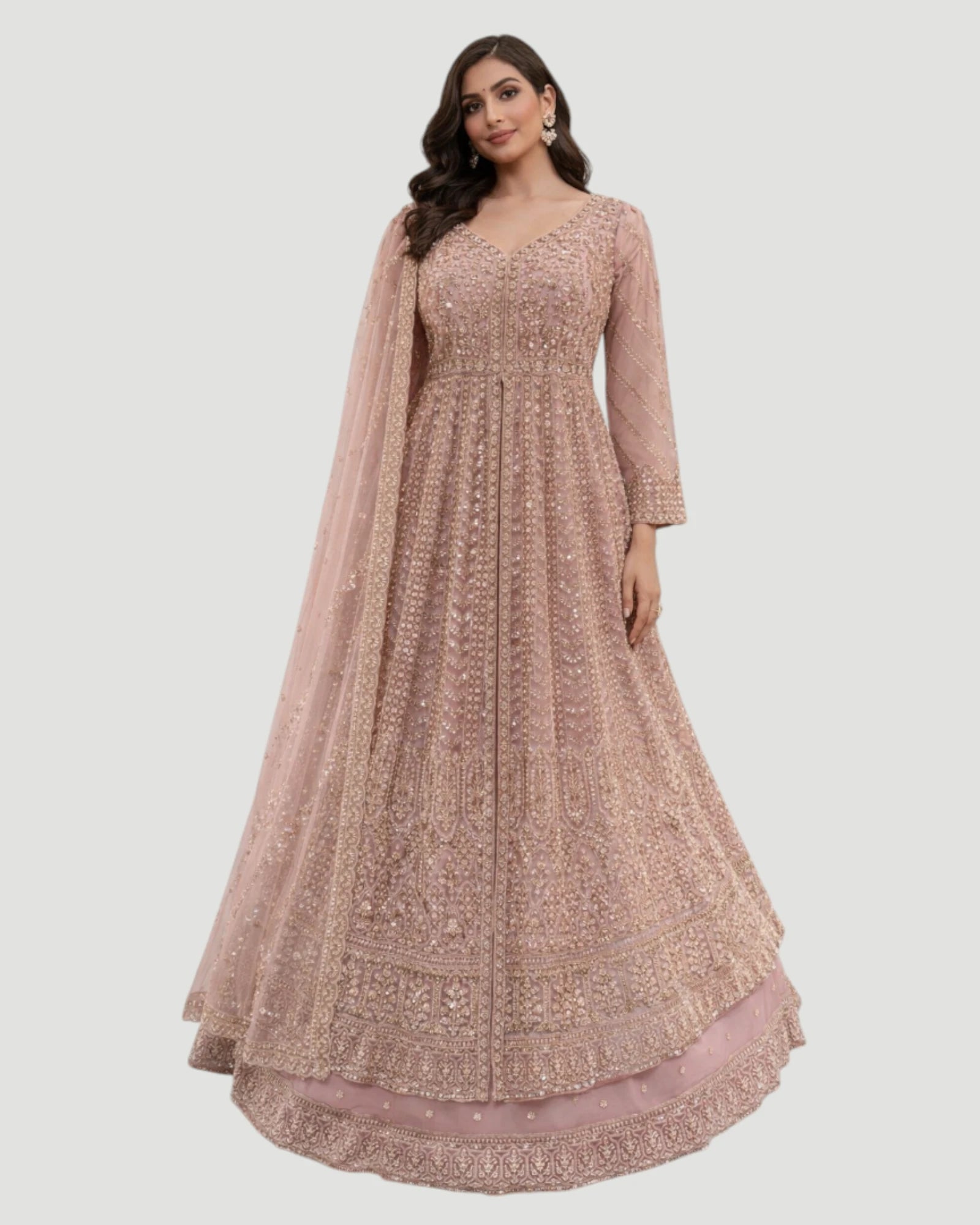 Woman wearing a long, patterned dress with a sheer dupatta on a white background