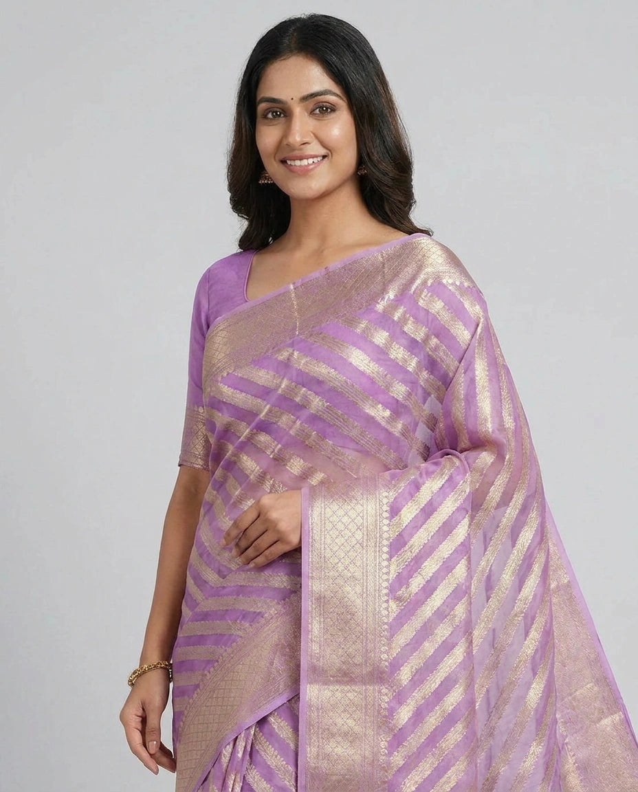Woman wearing a purple saree with a white background