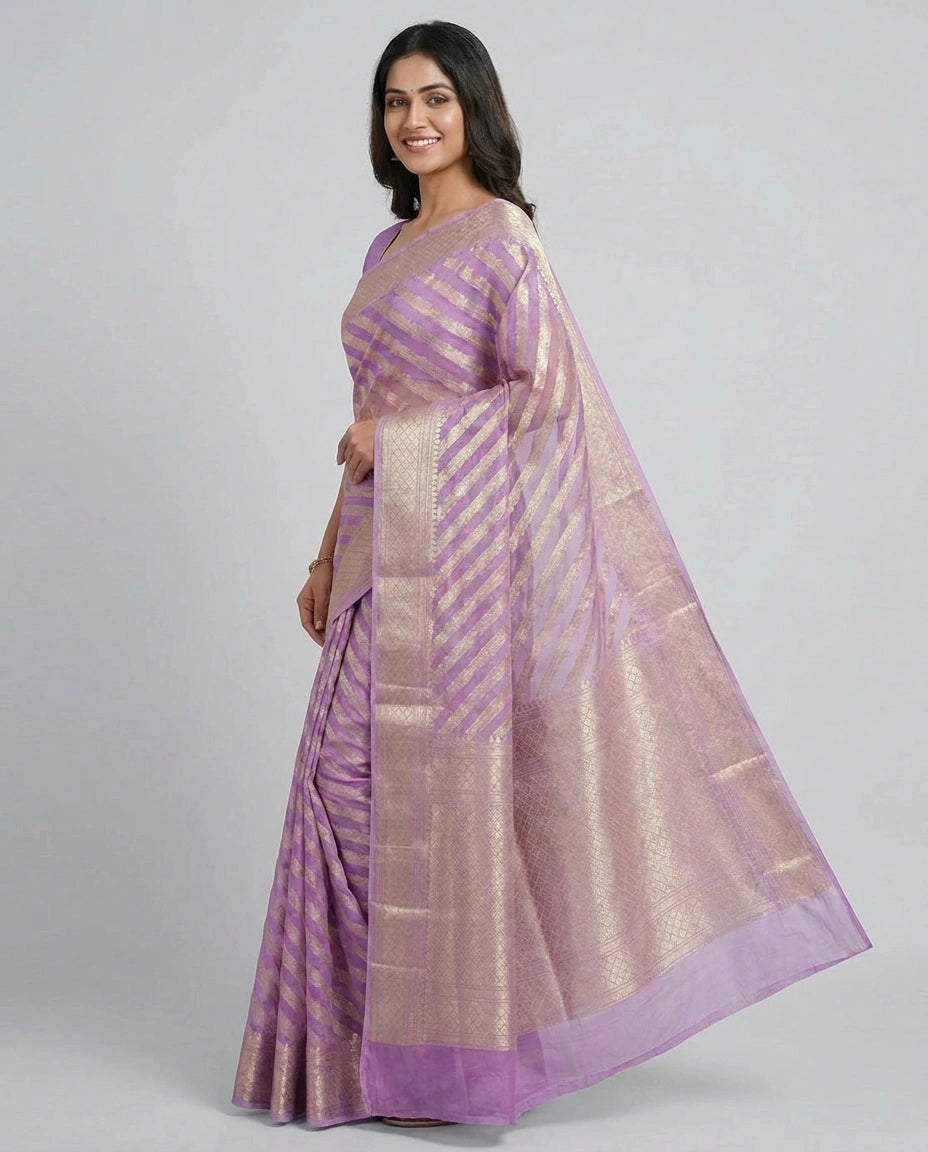 Woman wearing a purple saree with a white background