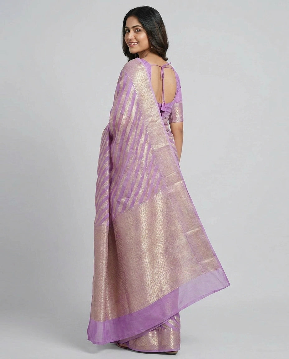 Woman wearing a purple saree with a white background