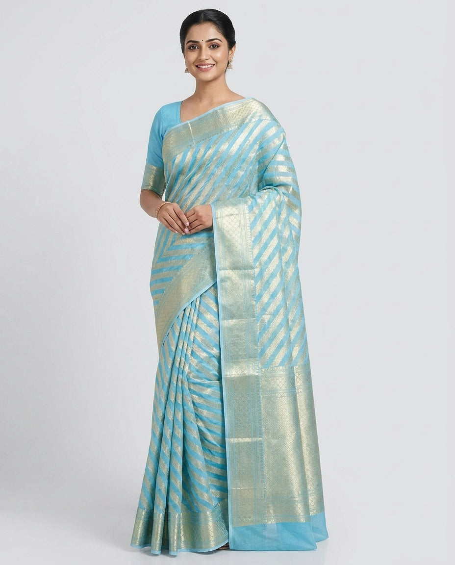 Woman wearing a light blue saree with a white background