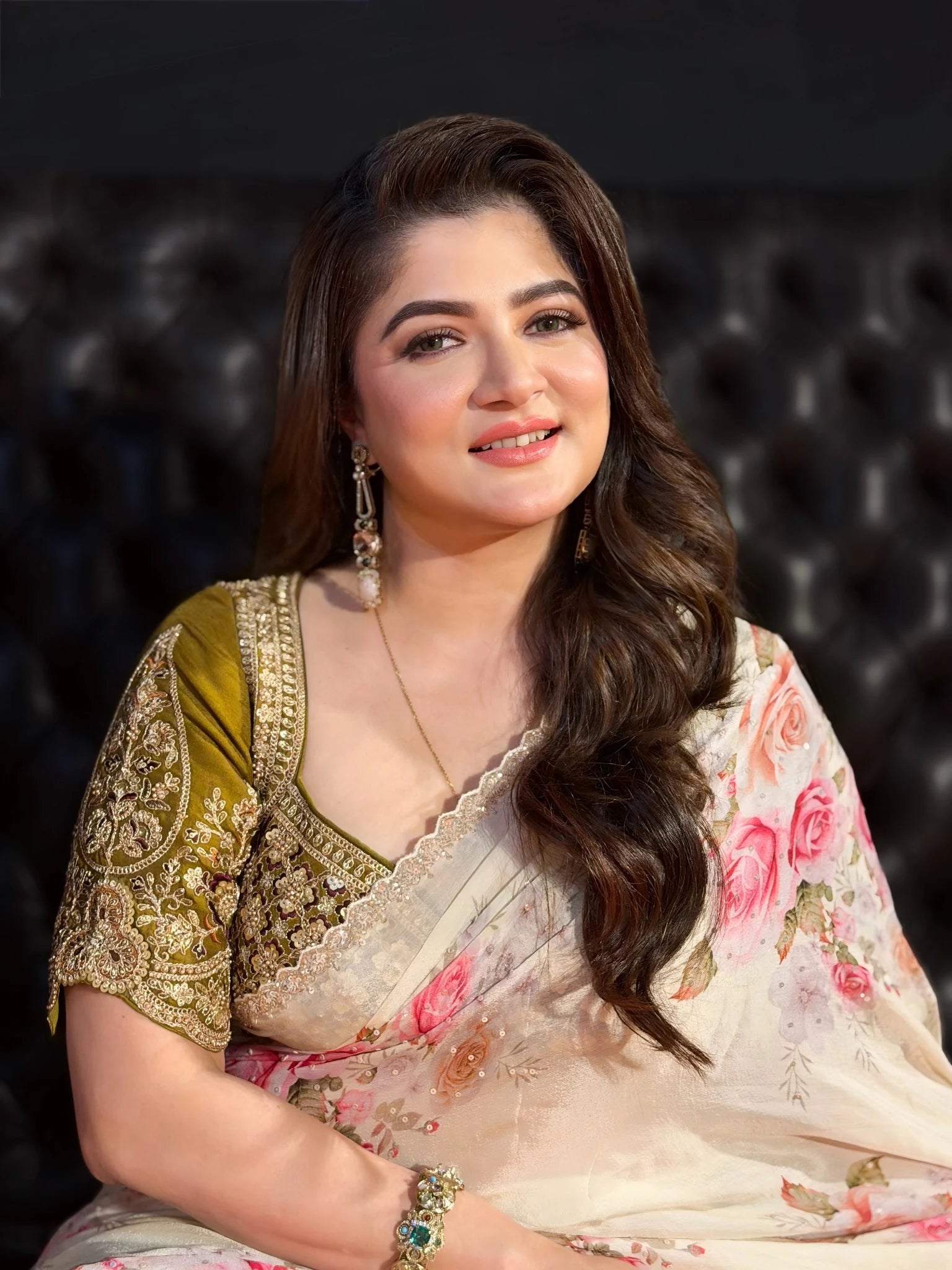 Woman in traditional attire with a dark background