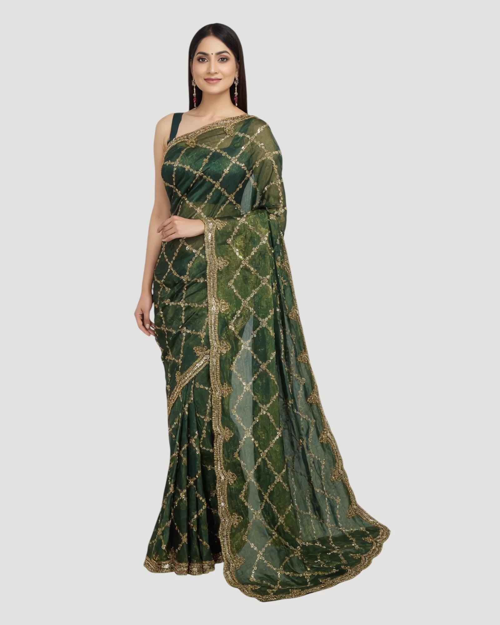 Woman wearing a green saree with gold patterns on a white background