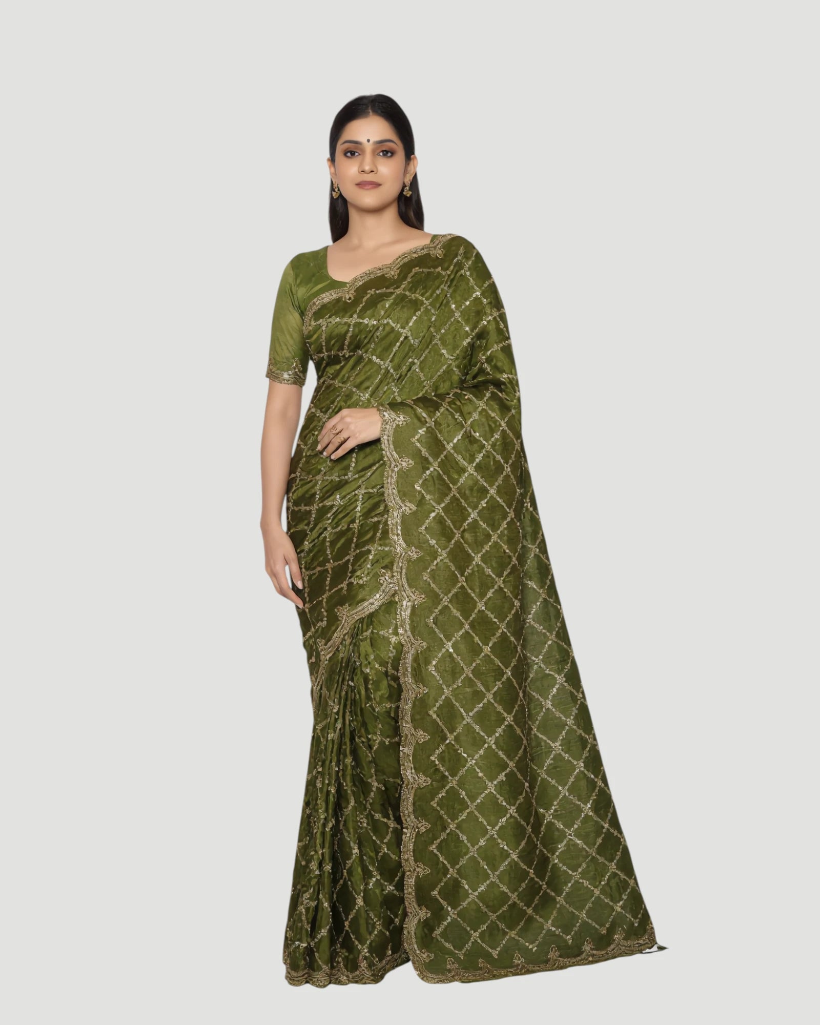 Woman wearing a green saree with a white background