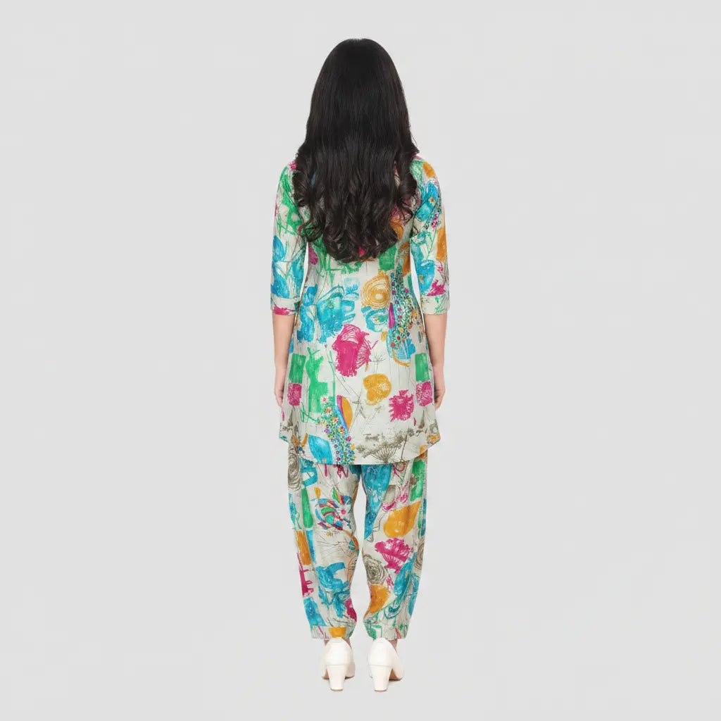 Woman wearing a colorful floral outfit on a plain background