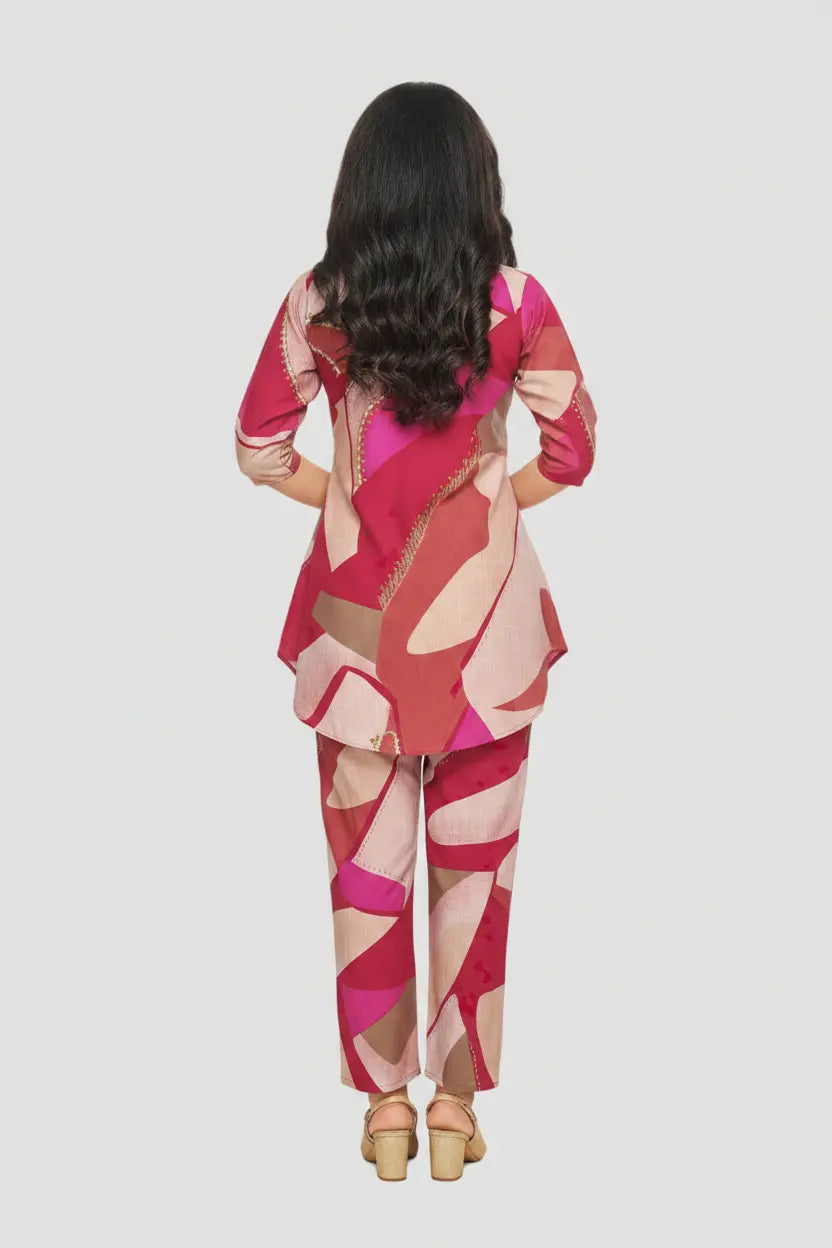 Person wearing a colorful geometric-patterned outfit on a light gray background