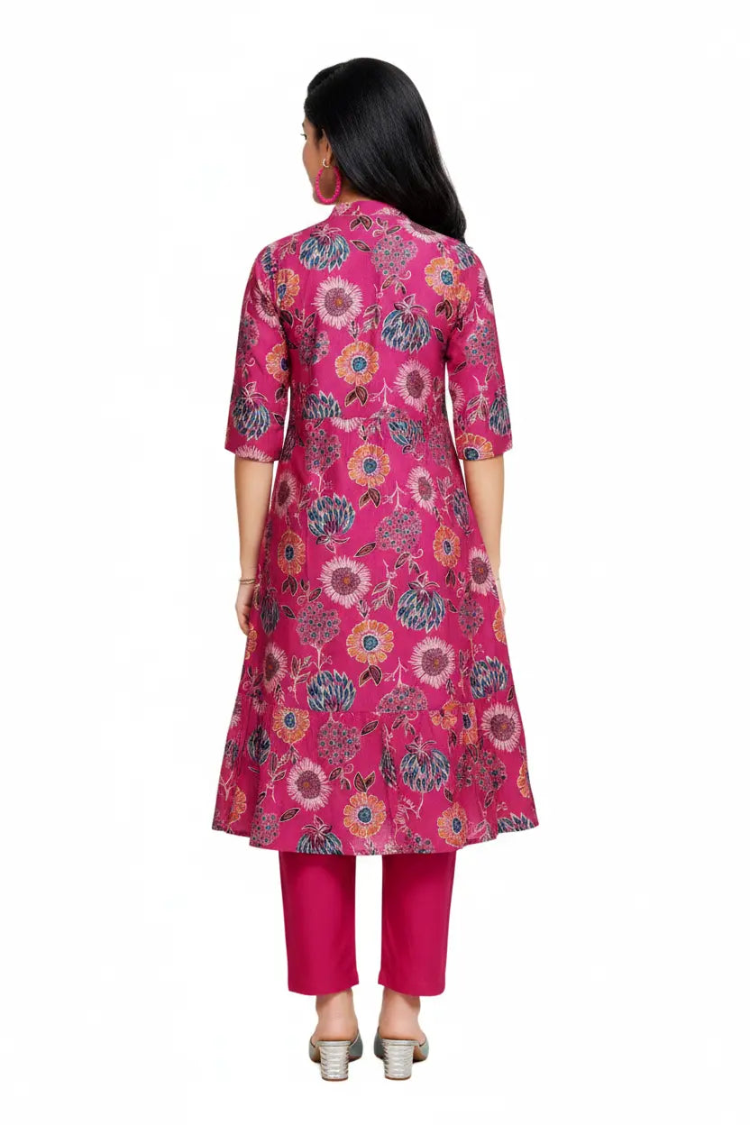 Woman wearing a pink floral kurta with pants on a white background