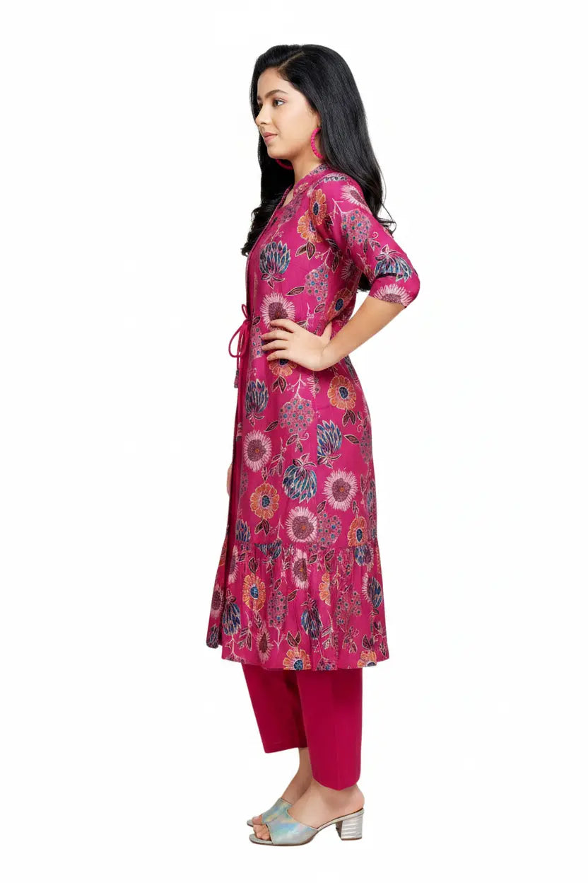 Woman wearing a pink floral kurta with pants on a white background