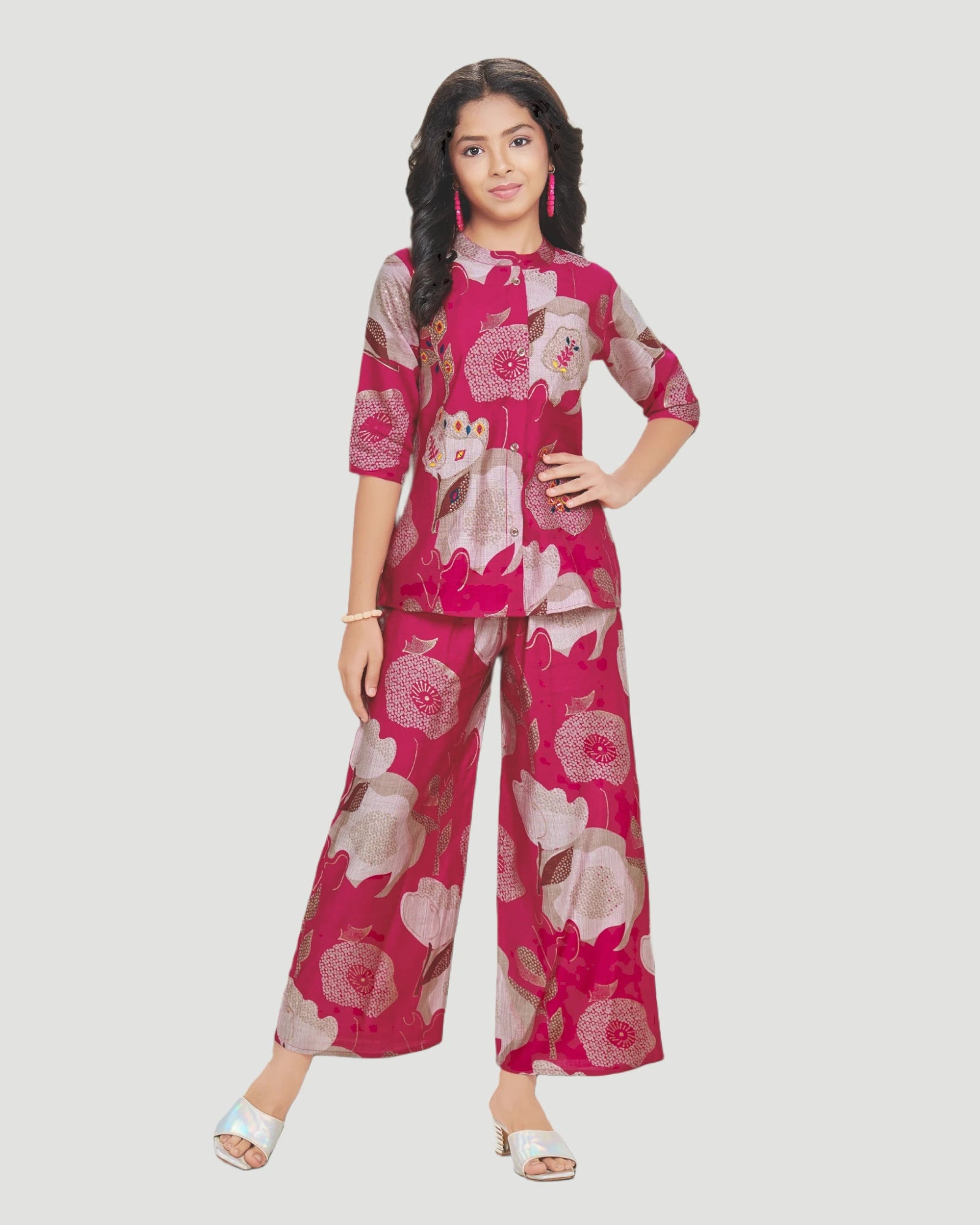 Woman wearing a pink floral outfit on a white background