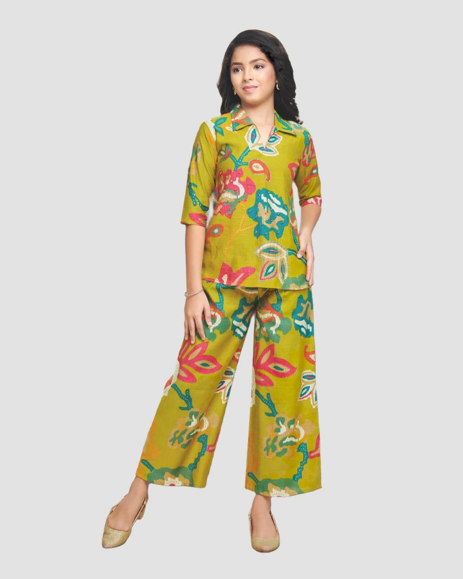 Woman wearing a green floral outfit on a gray background