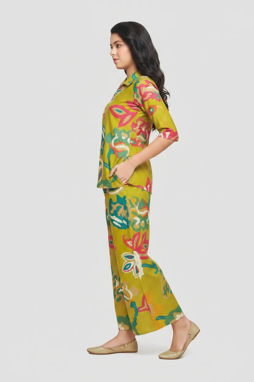 Woman wearing a colorful floral outfit on a white background