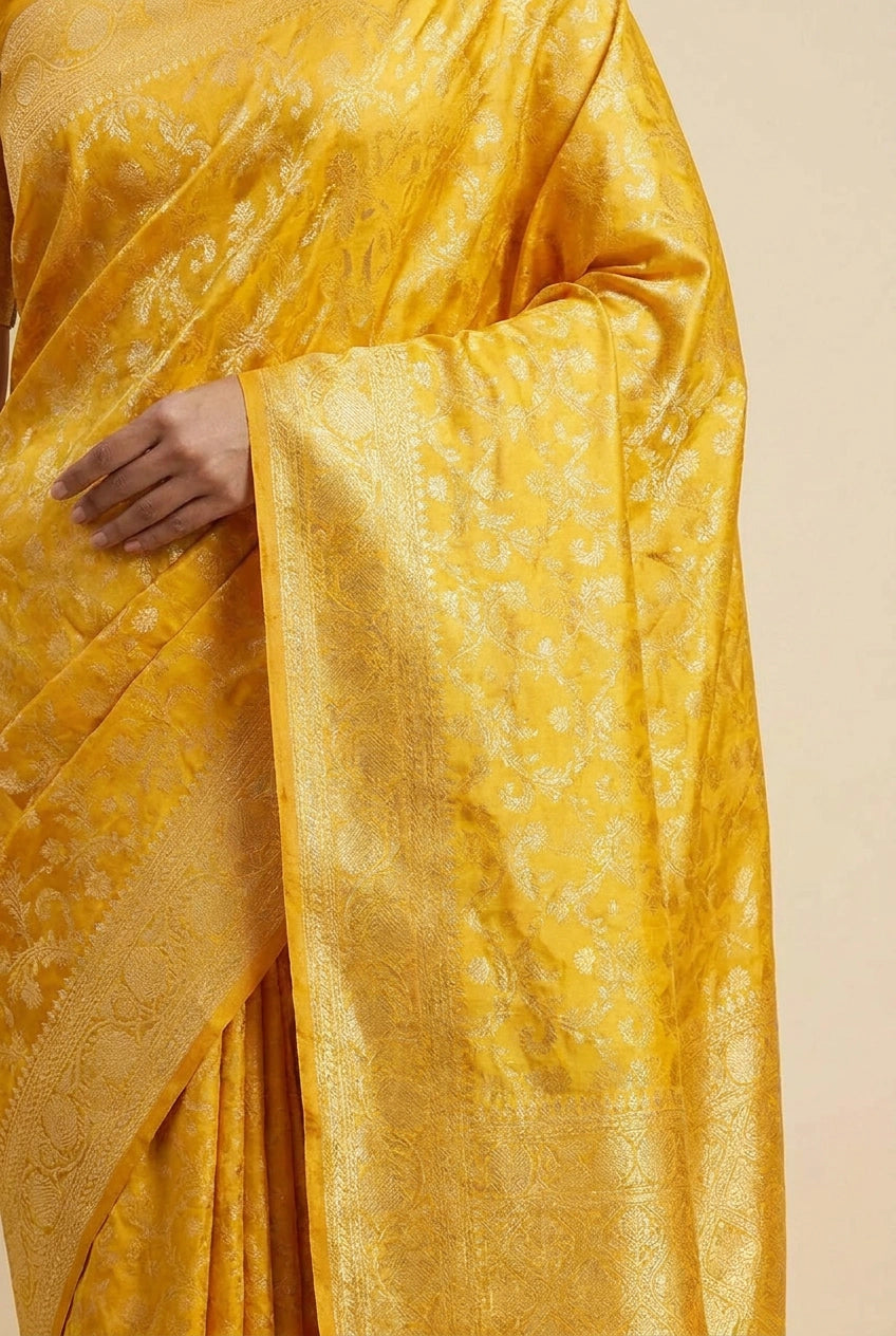 Yellow saree with intricate patterns on a beige background
