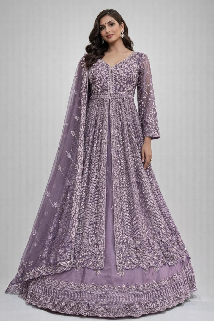 Woman wearing a purple embroidered anarkali suit with a matching dupatta on a light gray background