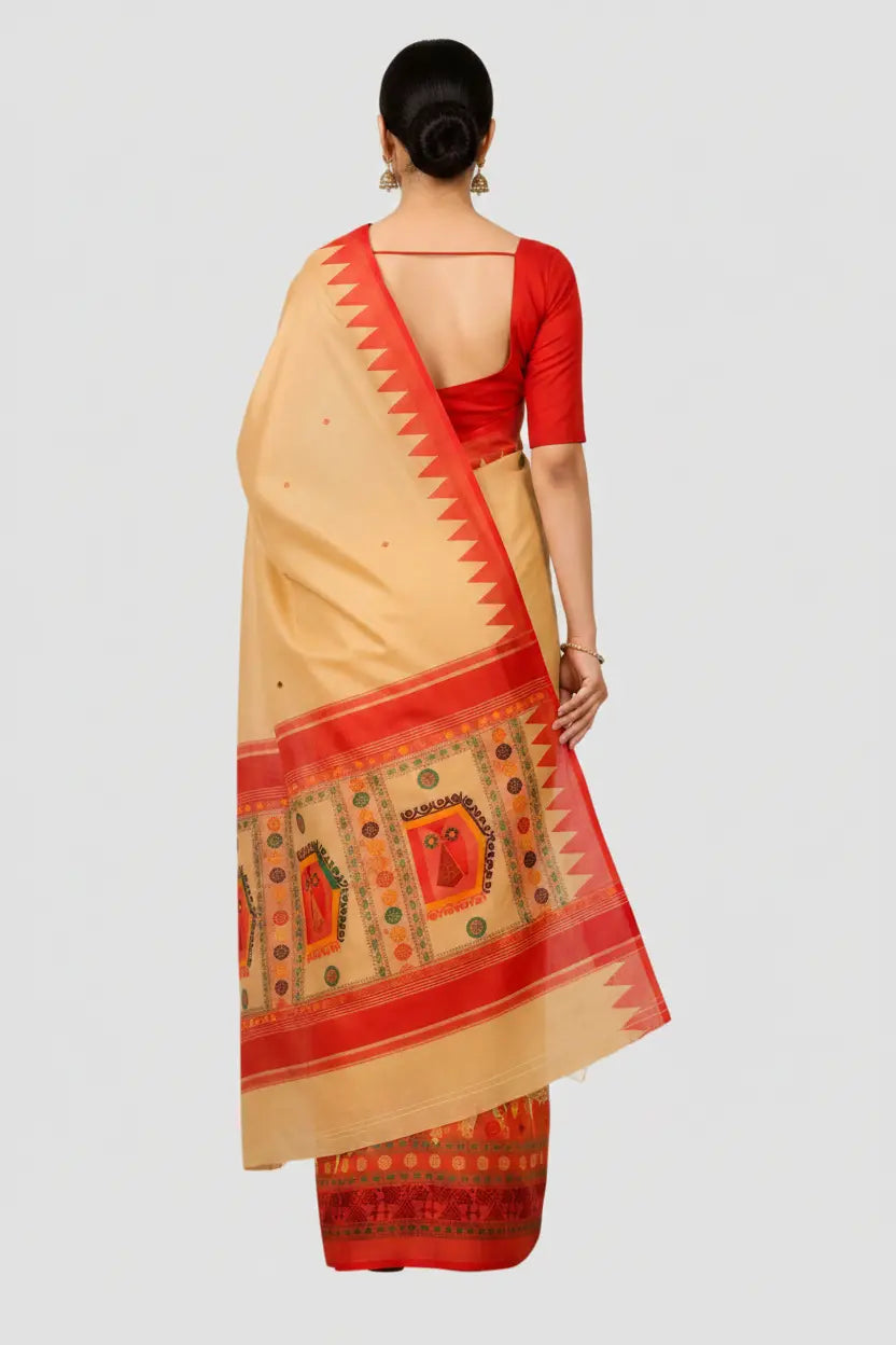 Woman wearing a beige and red saree with a plain background