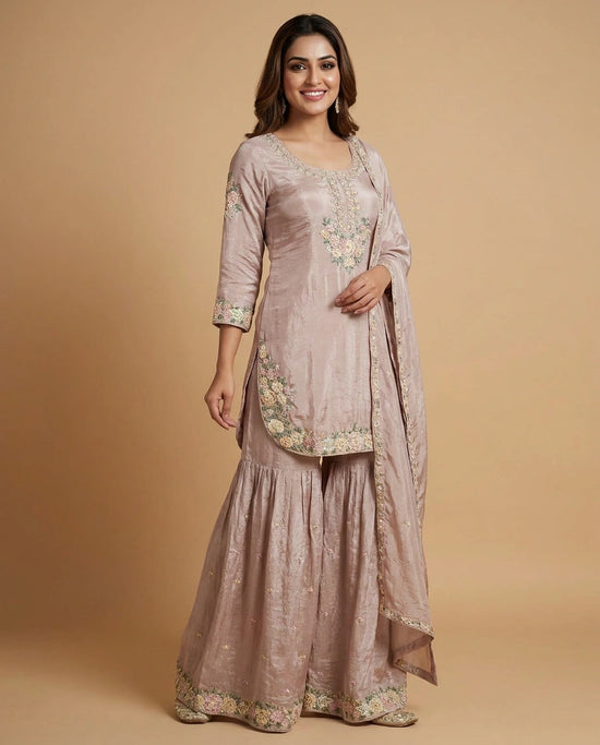 Woman wearing a traditional outfit with floral embroidery on a beige background