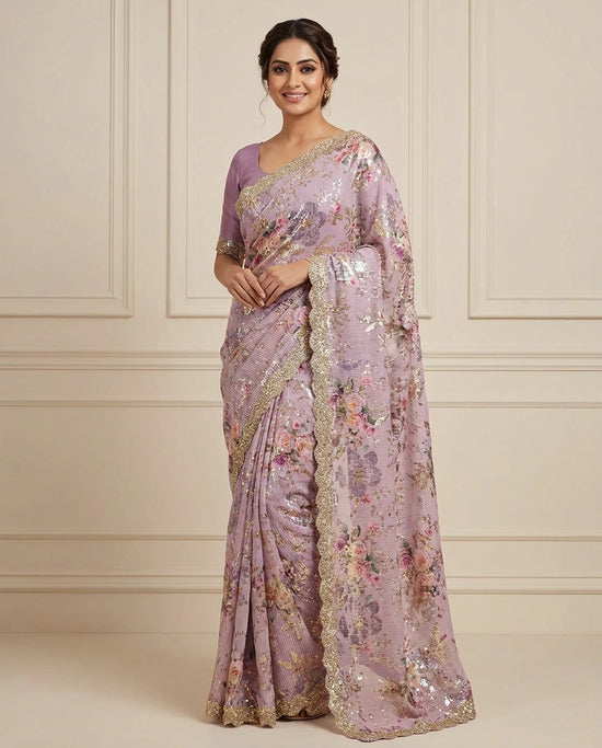 Woman wearing a floral saree with a matching blouse against a neutral background
