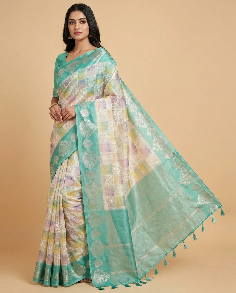 Woman wearing a light blue saree with a beige background