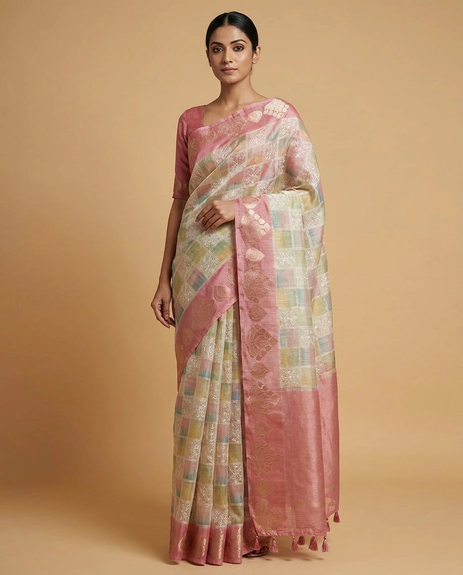 Woman wearing a pink and white saree with a beige background