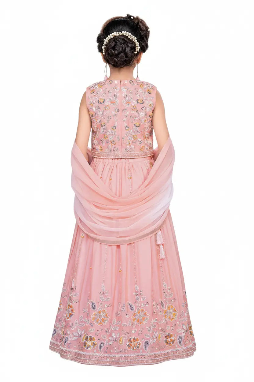 Pink embroidered traditional outfit with a draped fabric on a white background