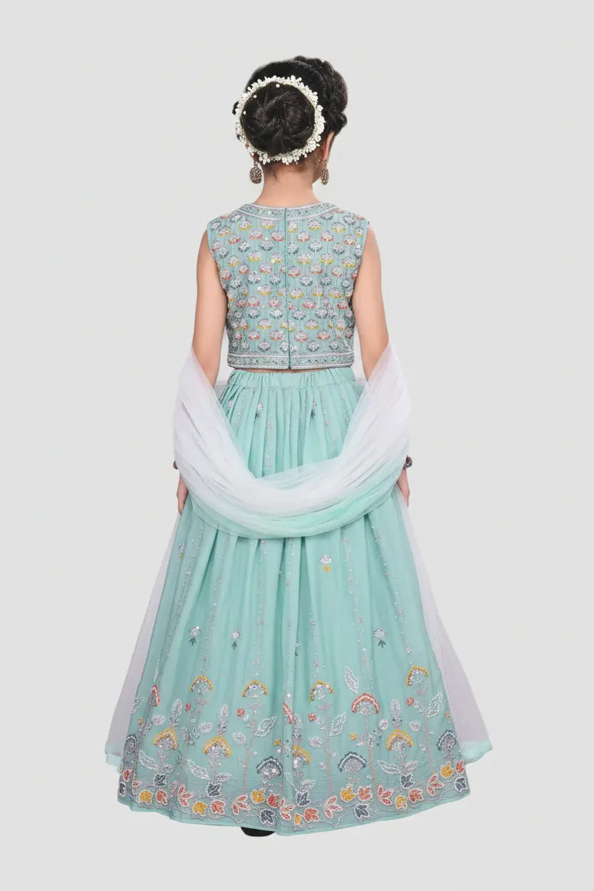 Light blue embroidered outfit with white dupatta on a plain background