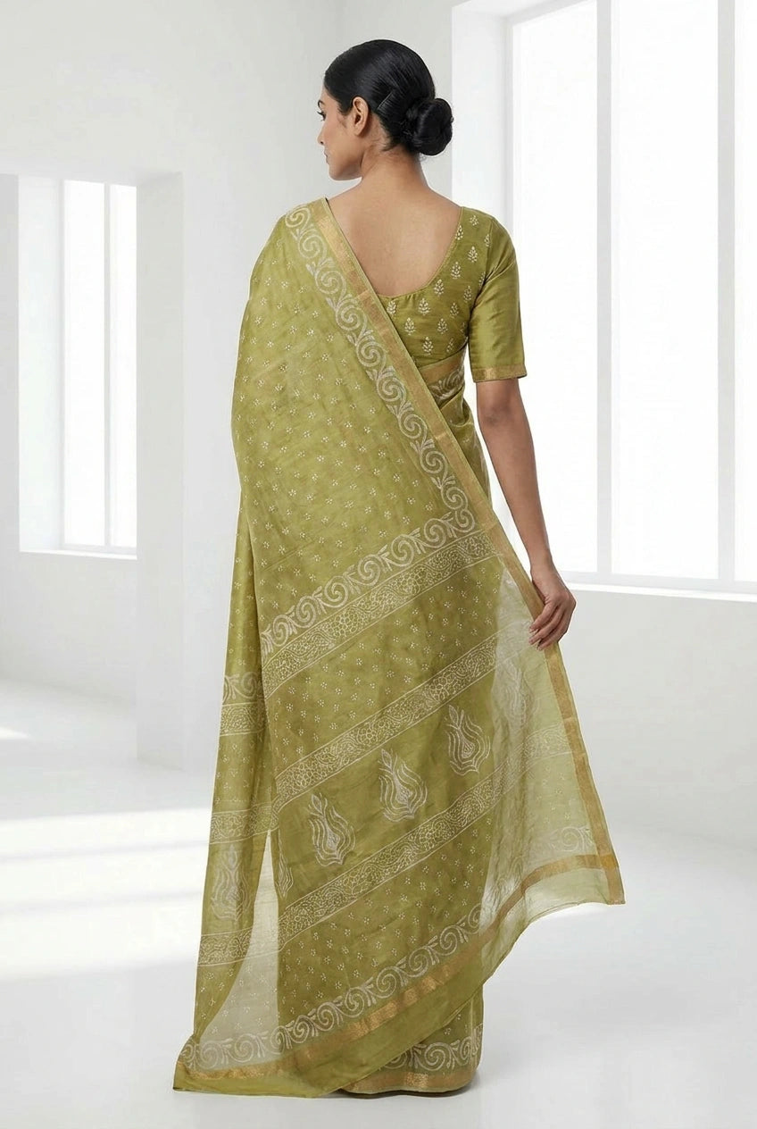 Woman wearing a green saree with a white background