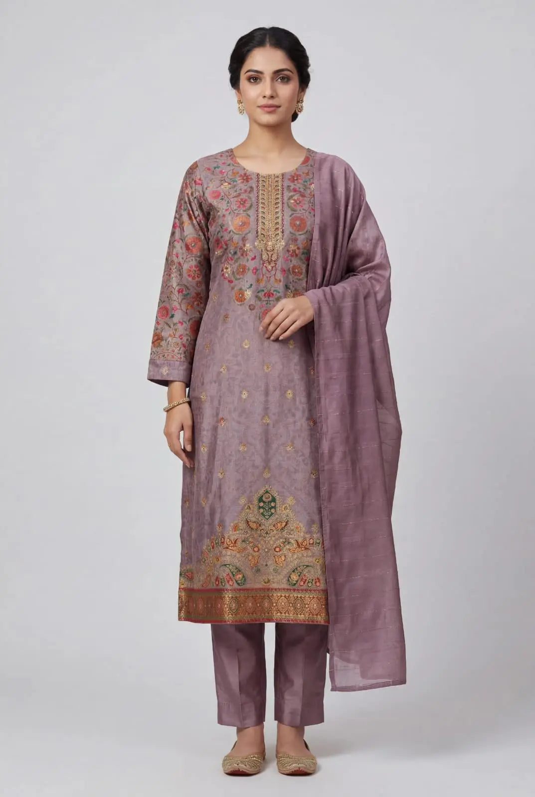 Woman wearing a mauve embroidered traditional outfit on a white background