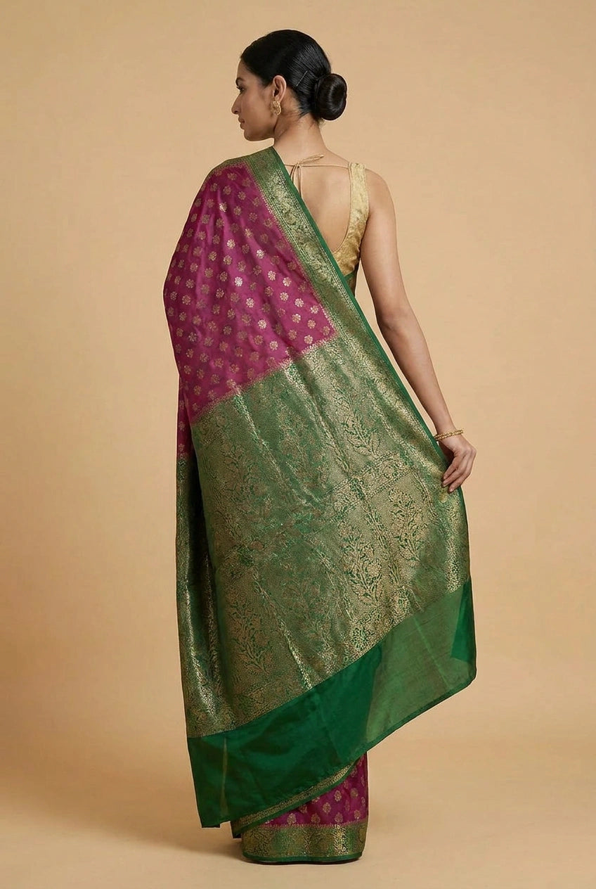 Woman wearing a green and pink saree on a beige background