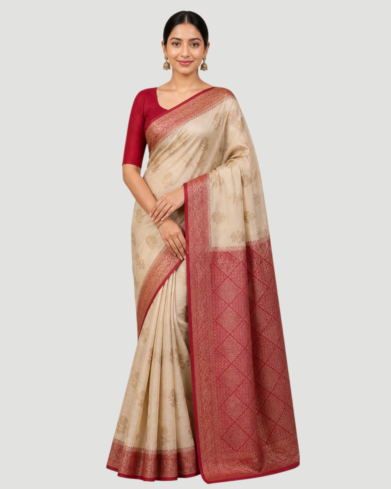 Woman wearing a beige and red saree on a white background