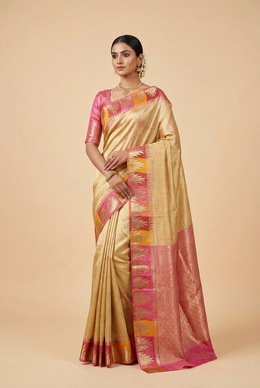 Woman wearing a traditional saree with pink and gold patterns on a beige background