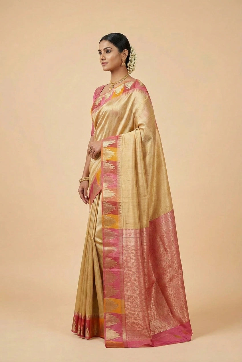 Woman wearing a gold and pink saree on a beige background