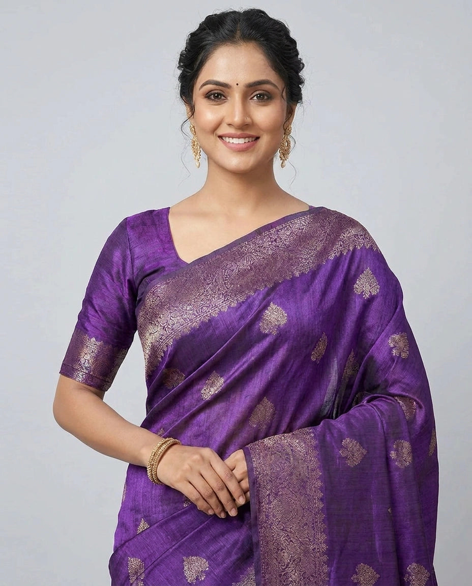 Woman wearing a purple saree with a white background