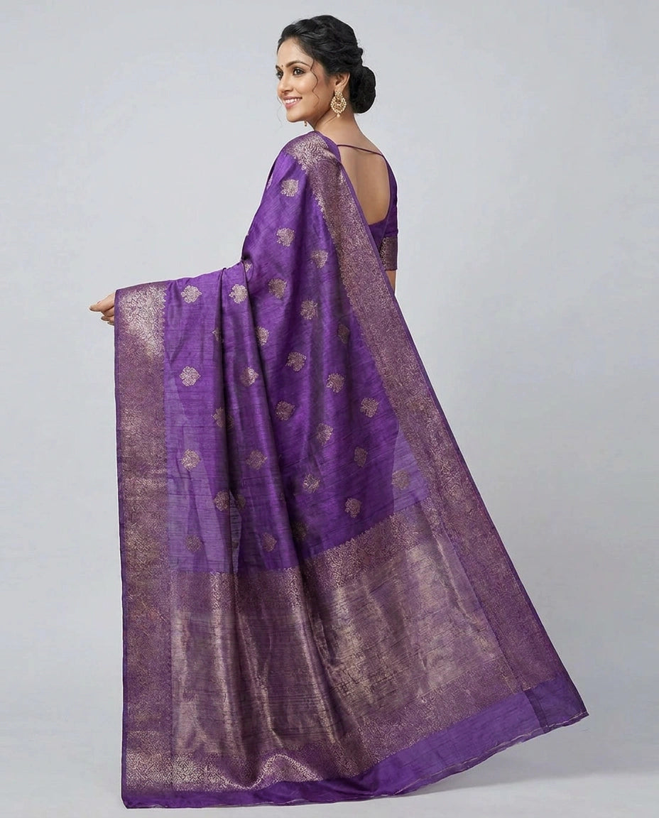 Woman holding a purple saree with a white background