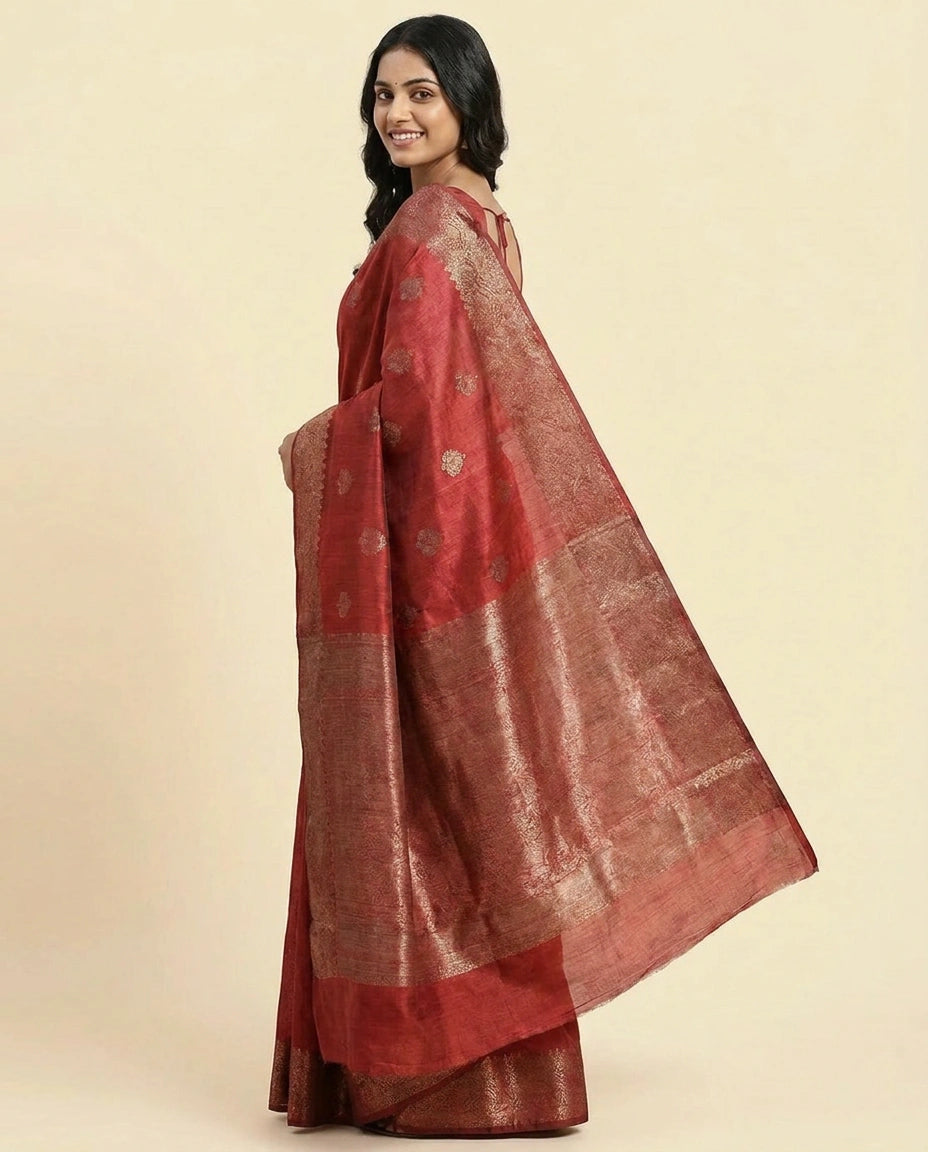 Woman wearing a red saree with a beige background