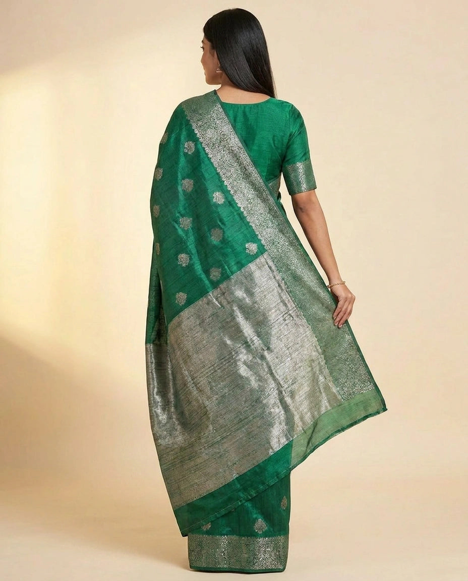 Woman wearing a green saree with a beige background