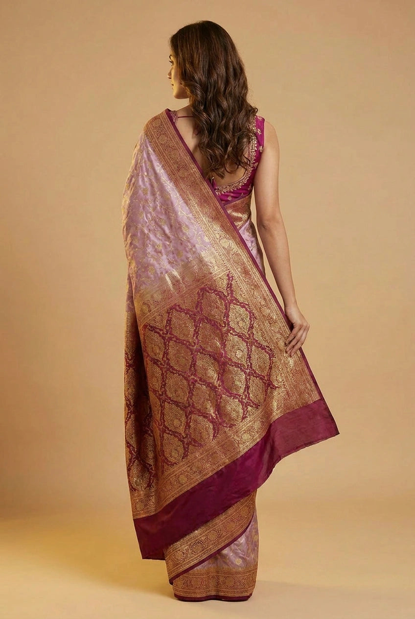 Woman wearing a traditional saree with intricate patterns on a beige background