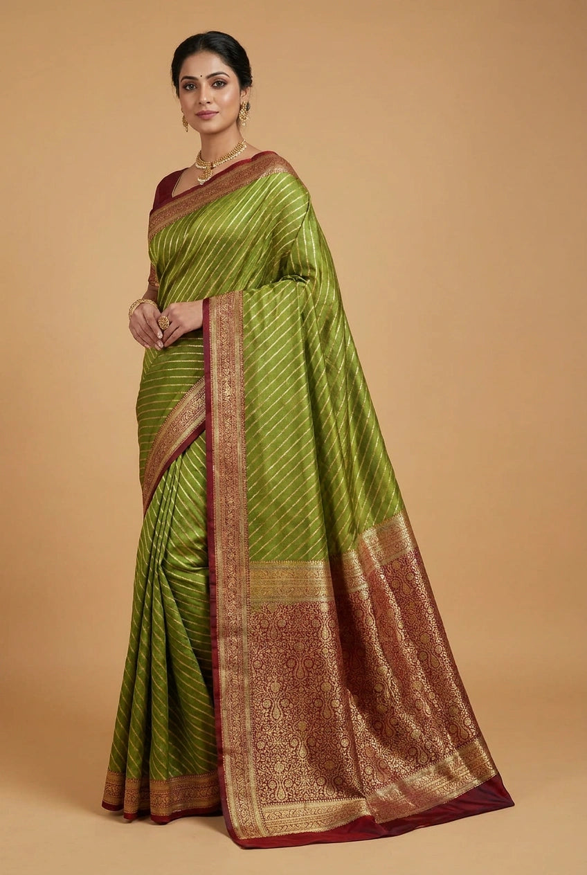 Woman wearing a green saree with a brown border on a beige background
