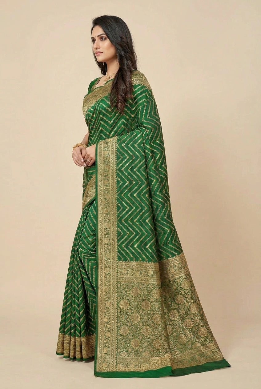 Woman wearing a green saree with a beige background